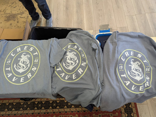 A Picture of three light blue shirts with a dtf transfer print on them